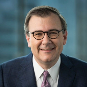 Man wearing glasses and a suit. 
